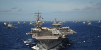 Aircraft carrier leads a naval fleet at sea