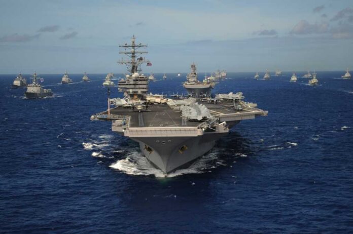 The,Nimitz-class,Aircraft,Carrier,Uss,Ronald,Reagan,Leads,A,Mass Aircraft carrier leads a naval fleet at sea