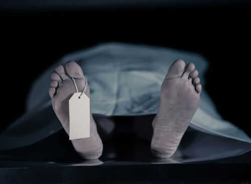 dead-body1552104335jpg Feet with tag under white sheet in morgue