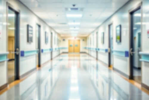 Blurred hospital corridor with doors and lights