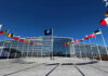 Russia Regroups—NATO Caught Napping NATO headquarters with member flags in front under a clear blue sky