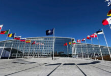 Russia Regroups—NATO Caught Napping NATO headquarters with member flags in front under a clear blue sky