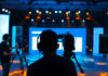 Tax War Guts LA—Jersey Rakes In Productions Cameramen preparing for a video shoot on a brightly lit stage