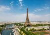 Priceless Eiffel Fragment: SOLD to Highest Bidder! Aerial view of the Eiffel Tower in Paris with the Seine River and cityscape