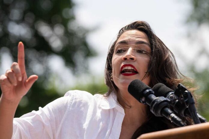 A woman passionately speaking at a podium with microphones