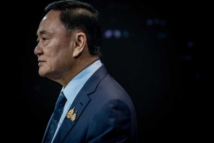 Profile portrait of a man in formal attire with a pin on his lapel