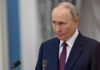 Putin’s Alarming Power Grab – Troops on the Move? A serious-looking man in a suit during a press conference