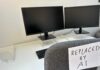 White-Collar BLOODBATH Incoming? Shocking AI Threat An office desk with two computer monitors and a chair labeled 'REPLACED BY AI'