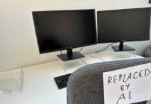 White-Collar BLOODBATH Incoming? Shocking AI Threat An office desk with two computer monitors and a chair labeled 'REPLACED BY AI'