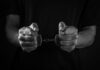Alleged Killer Charged: Was It a Job Trap? Hands holding handcuffs in a black and white image