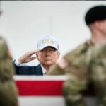 Trump $250 Note? Congress Holds the Power A man in a USA hat saluting during a military ceremony