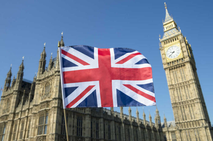 Union Jack flag in front of Big Ben and the Houses of Parliament