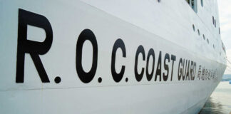 R.O.C. Coast Guard lettering on the side of a white ship at dock
