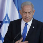 Pentagon Leak: Israel Top Spy Threat — White House Denies Man speaking in front of Israeli flag backdrop