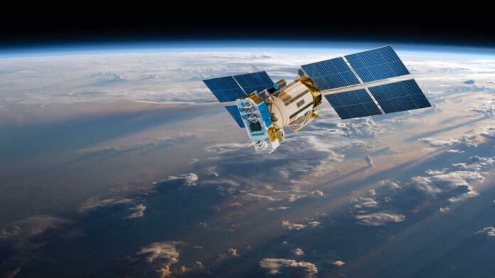 A satellite equipped with solar panels orbiting above the Earth, surrounded by clouds