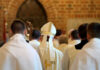 $300M Shock: Parish Wallets On The Line Clerics in white robes facing altar in church