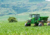 Trump Breaks From His Tariff Playbook — Farm Equipment Gets Relief Green tractor working on a lush field landscape