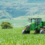 Trump Breaks From His Tariff Playbook — Farm Equipment Gets Relief Green tractor working on a lush field landscape