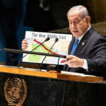 America First Clashes With Bibi’s Iran Gambit Speaker at UN podium holding a Middle East map