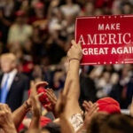 MAGA Isn’t Fracturing — Polls Show Frustration, Not Collapse Crowd holding red Make America Great Again sign