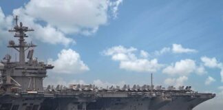 Aircraft carrier leads a naval fleet at sea