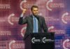 Person speaking at Turning Point USA event podium