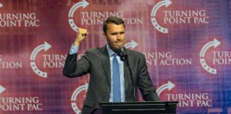 Person speaking at Turning Point USA event podium