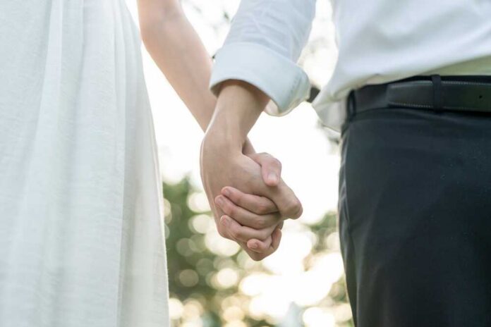 Close,Up,Of,Married,Couple,Holding,Hand,Each,Other,In Ballot paper for governor election candidates listed.