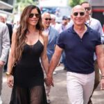 Billionaire Glow-Up Sparks HGH Whispers Man in a suit smiling outdoors.