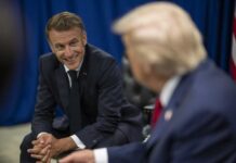 Macron’s Versailles Power Play Two political leaders engaged in a conversation, one smiling
