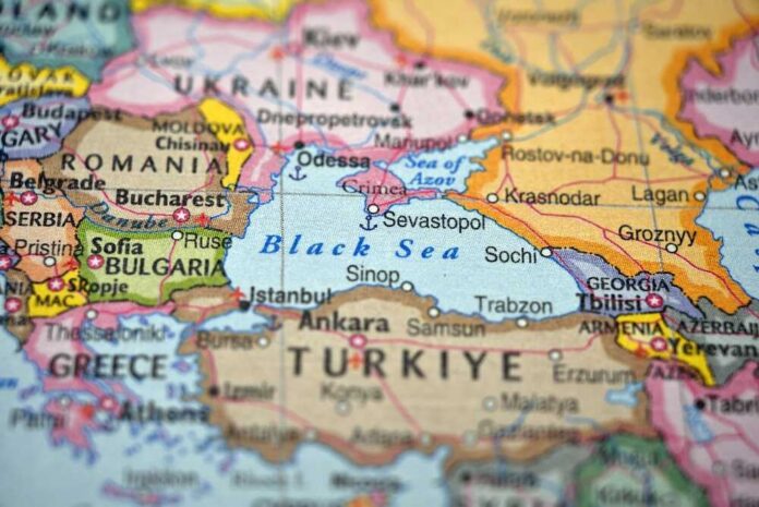 Defocused,Map,Background,Highlighting,Black,Sea,Geography,And,Travel,Concept Aerial view of multiple naval ships operating in the ocean