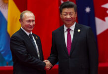 U.S. Blunder Forges China–Russia Power Axis Two international leaders shaking hands at a diplomatic event