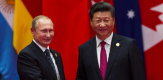 Two international leaders shaking hands at a diplomatic event