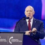 Person speaking at Turning Point USA event podium