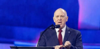 Person speaking at Turning Point USA event podium
