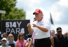 Manhattan Power Seat: Trump’s Controversial Choice Man in red cap and white golf shirt gesturing at a golf event