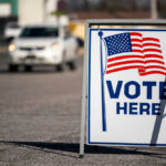 Four GOP Defections Block SAVE Act Vote Here sign with American flag.