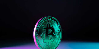Green Bitcoin coin on purple and blue background
