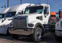 Billion-Dollar Relief For Diesel Owners White heavy-duty semi truck in a dealership lot
