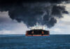 Hormuz Explodes — US Hits Back Hard Large ship emitting thick black smoke at sea