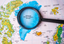 Magnifying glass over map of Greenland and Arctic Ocean