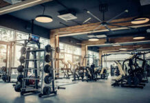 Modern gym with fitness equipment and weight racks
