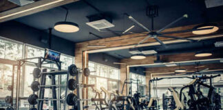 Modern gym with fitness equipment and weight racks