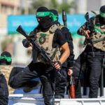 UN Bombshell: Hamas Blocks Lifesaving Aid Masked men with firearms standing on a vehicle