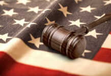 Jury Door Getaway — Accountability Missing Judge’s gavel on a folded American flag