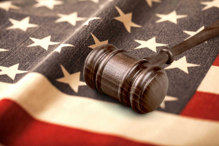 judges-wooden-gavel-and-usa-flag2476779273jpg Judge’s gavel on a folded American flag