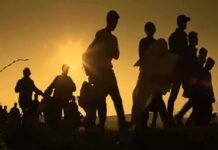 Schengen Showdown: Meloni Threatens Spain Freeze Silhouettes of people walking at sunset