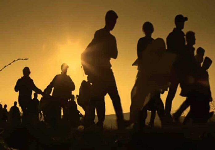 shutterstock_1008288460 Silhouettes of people walking at sunset