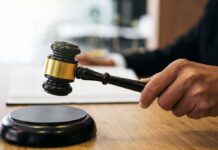 Biden-Era Bust Backfires — Trump DOJ Pays Judge's hand holding a gavel over a sound block