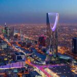 US Hub Blitzed — Casualties Kept Murky Kingdom Centre Tower illuminated over a sprawling city at dusk